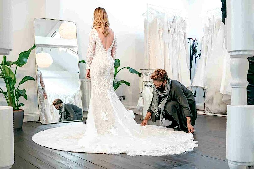 Shortening the train of a Wedding Dress in our bridal boutique in London